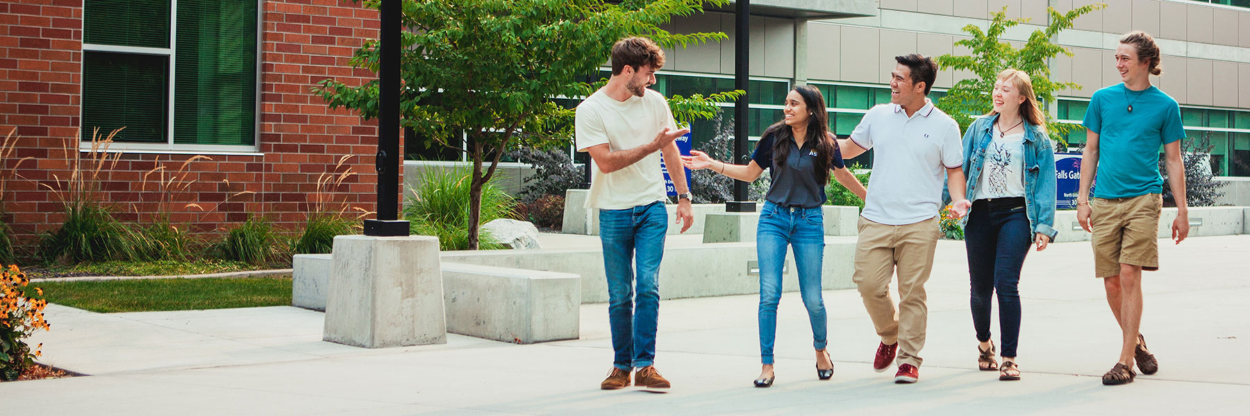 Students talking and walking across campus